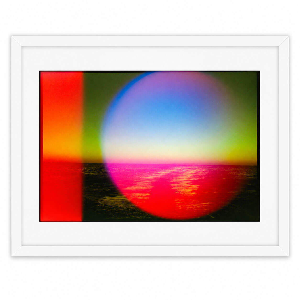 A framed abstract art print featuring a vibrant multicolor design with a large pink and blue circular shape, a vertical red and yellow stripe on the left, and a dark textured base, all enclosed in a white frame.
