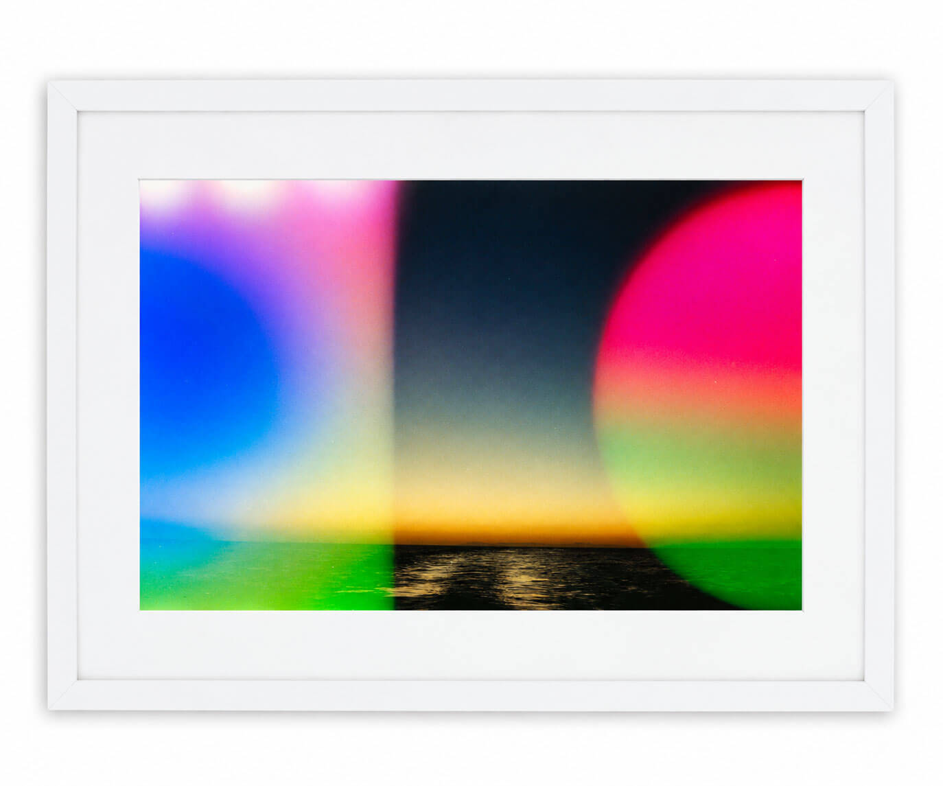A framed abstract landscape art print featuring a sunset over water with vibrant neon color overlays, presented in a white frame against a clean white background.