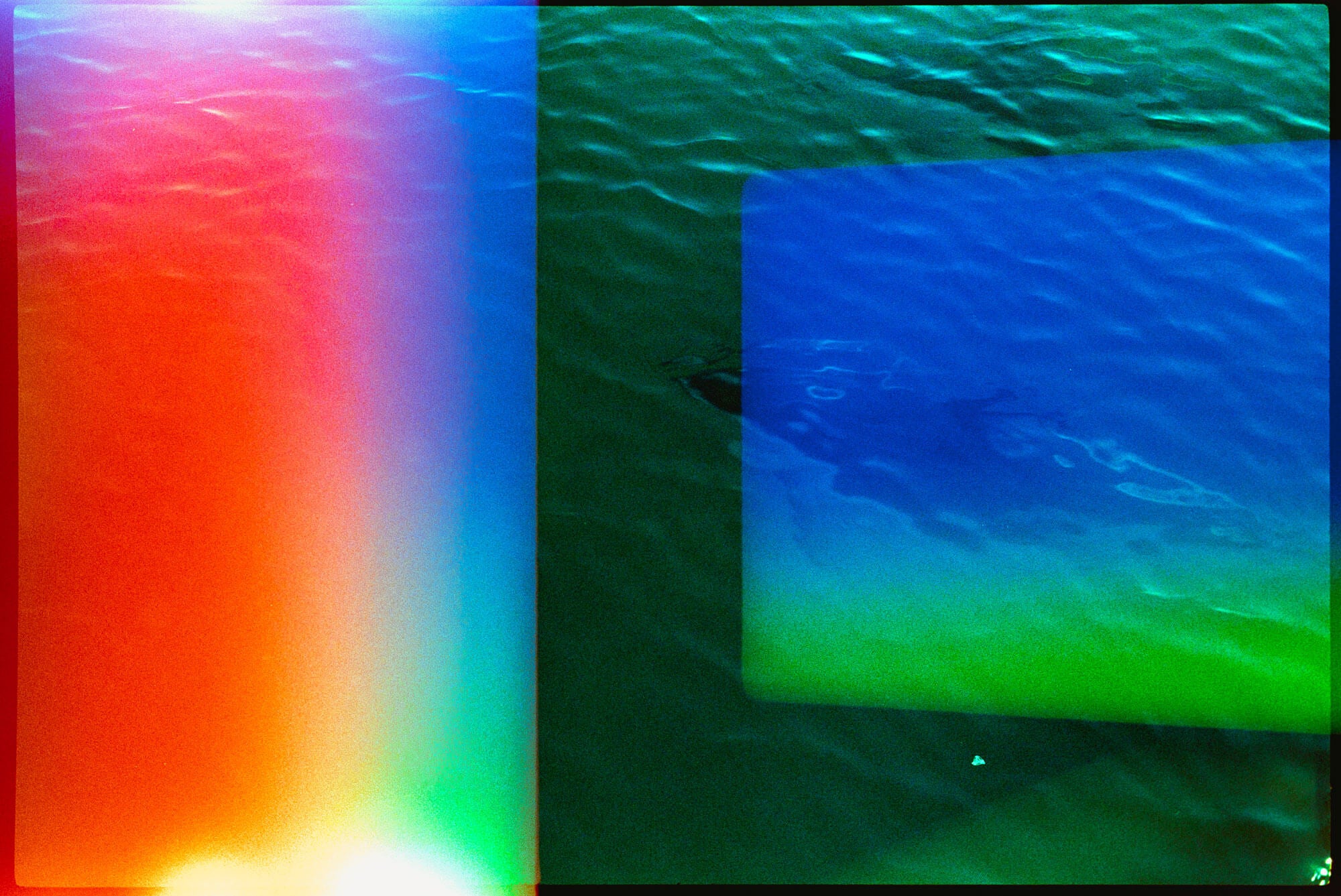 A square abstract art print featuring a split composition: the left half shows a vertical rainbow gradient from red and orange to green, blue, and white light, while the right half depicts rippling water with a blue rectangle overlay showing green and blue tones.